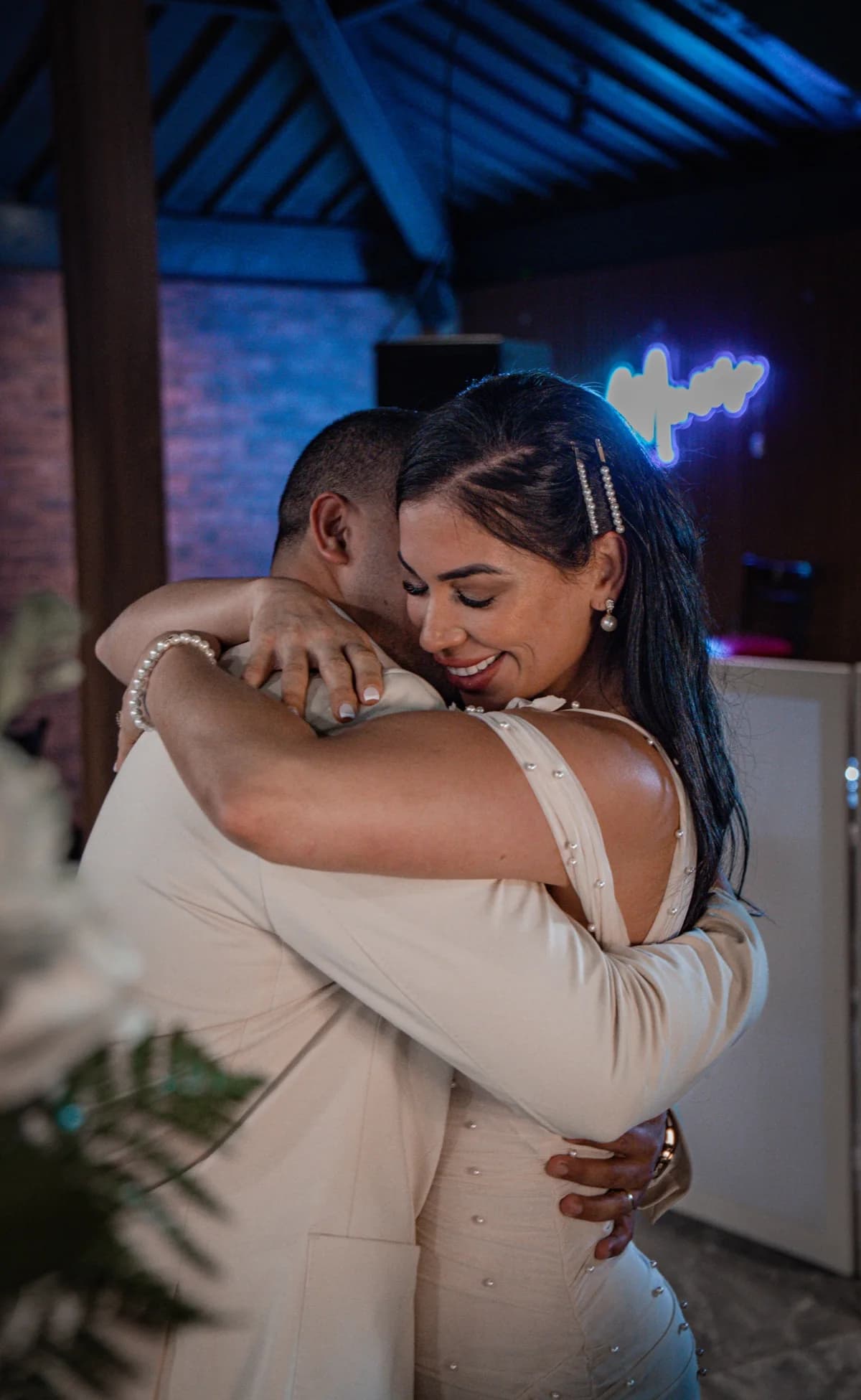 A wedding couple embracing under blue evening light